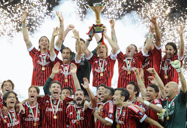 AC Milan players hold the Scudetto troph